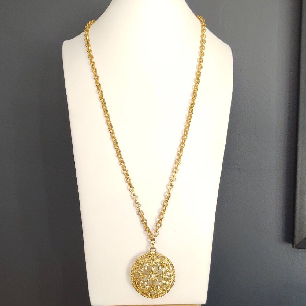 Vintage gold tone pendant necklace with underside magnifying glass and cz accent